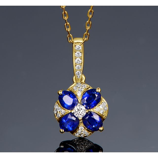 Pendentif solitaire fleur bleue. Or jaune, saphirs et diamants