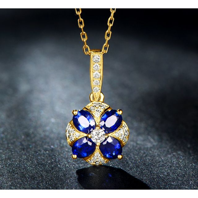 Pendentif solitaire fleur bleue. Or jaune, saphirs et diamants